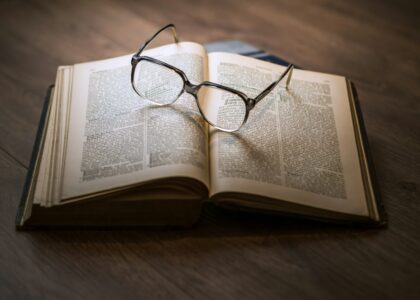 Framed Eyeglasses On Top Open Book